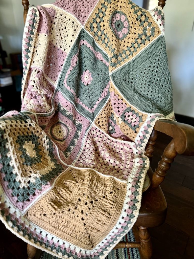 A blanket made with squares of crocheted granny squares.